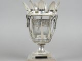 a silver cup with spoons and spoon spoons in it