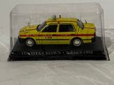 a yellow taxi car in a glass case