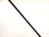 a close up of a metal stick with a handle on a white surface