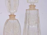 three glass vases sitting next to each other on a white surface