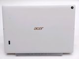 the back of a white laptop computer sitting on top of a white table