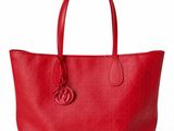 a red leather tote bag on a white background