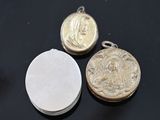 two silver and gold lockes on a black surface