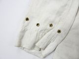 a close up of a white sweater with gold buttons