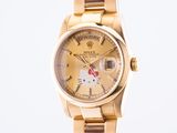an image of a hello kitty watch on a gold bracelet