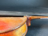a close up of a violin on a black surface