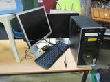 two computer monitors and a keyboard on a desk