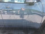 a reflection of a person in the side of a car