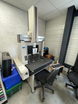 a desk with a computer and a chair in a room