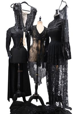 three dresses on a mannequin stand and a dress on a mannequin stand