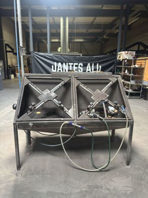 a table with a bunch of tools on it in a warehouse