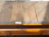 a wooden table with a drawer on top of it