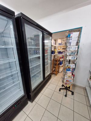 two refrigerators that are sitting in the middle of a store