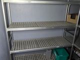 a metal shelf with shelves in the corner of a room