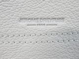 a close up of a white leather bag with the name of the bag