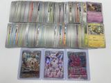 a lot of different pokemon cards on the table