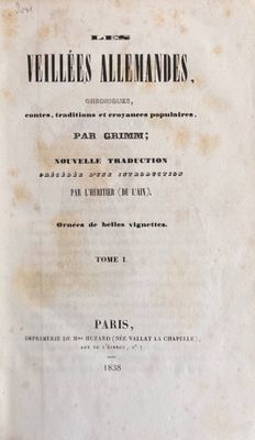 an old book with black writing on it sitting on a table