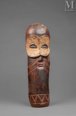 a wooden mask with a face and a beard