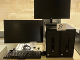 two computer monitors and a keyboard on a desk