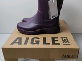 an image of a pair of purple rain boots sitting on top of a box