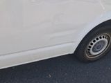 a white van that is parked on the side of the road
