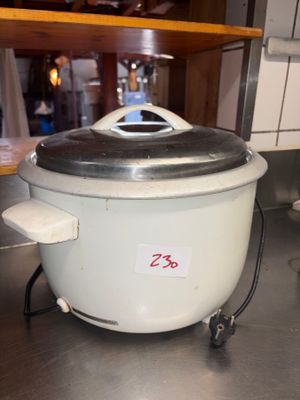 a white crock pot with a lid on a kitchen counter