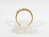 an image of a gold ring with five diamonds on it