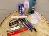 a table with a lot of cosmetics and makeup products on it