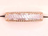 a close up of a wedding ring on a white cloth