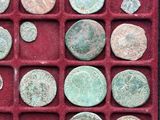 a red box filled with lots of old coins