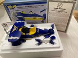 a blue and yellow model of a plane on a table