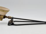 an antique brass coffee grinder on a white background
