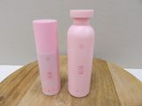 two pink water bottles sitting on a wooden table