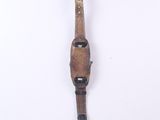 leather watch strap with metal buckle on a white background