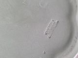 the bottom of a white shoe with a small hole in it