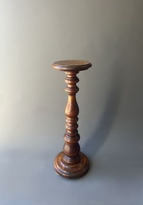 an old wooden candle holder on a grey background