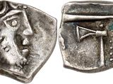 a close up of a coin with a cross on it