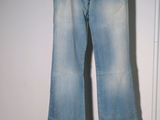 jeans hanging on a hanger in front of a white door