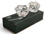 a pair of crystal candlesticks sitting on a black box