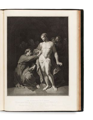 un vieux livre avec une image de Jésus sur la couverture