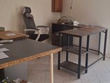 a desk with a chair and a chair in the room
