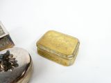 a small silver box and a small silver box on a white surface