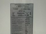 a label on the side of a white refrigerator