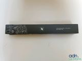 an open box of mascara sitting on top of a white table