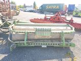 an image of a tractor and other machinery in a parking lot