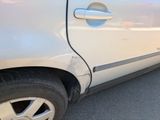 a white car that has a dent in the side of it