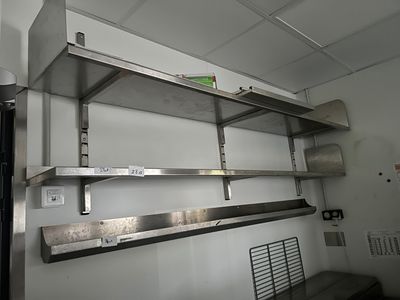 a metal shelf that is hanging from the ceiling