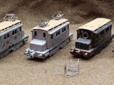 several toy trains are lined up in a row on a table
