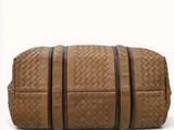 the large tan leather bag has two zippers on the side