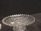 a glass bowl and a glass plate sitting on a table